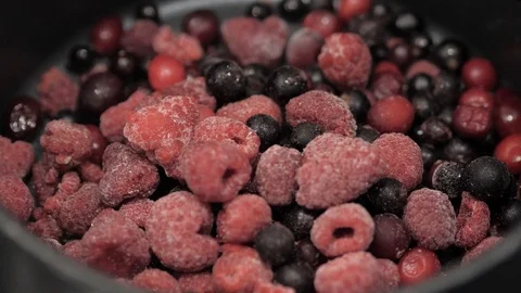 Frozen red berries thaw in accelerated motion, closeup. Stock Footage 126150941