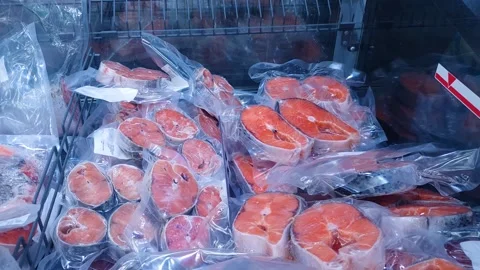 Frozen red fish steaks, sliced trout, and vacuum-packed salmon. Stock Footage 348108677
