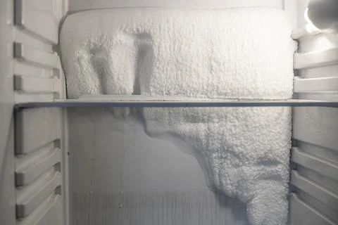 Frozen refrigerator that needs to be defrosted. Stock Photos