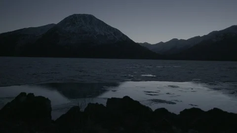 Frozen river and mountain ranges at sunset Stock Footage 104525606