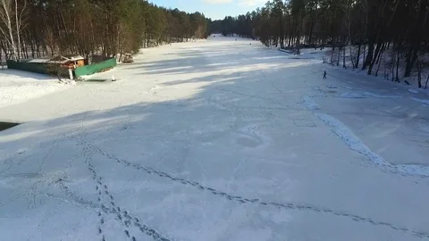 Frozen river bed in winter forest. Aerial view. Stock-Footage 72512616