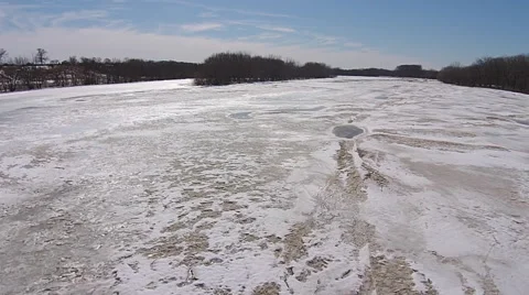 Frozen river camera moving across ice at low altitude Stock Footage 49738283
