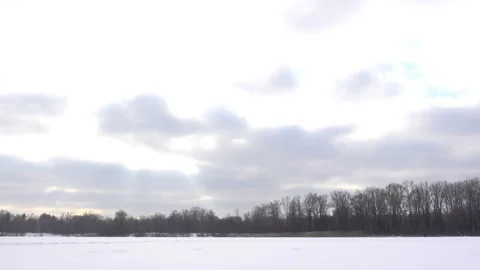 Frozen river covered with snow with clouds in time laps. Stock Footage 165278425