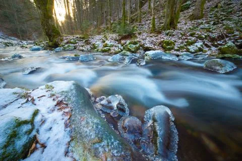 Frozen river in the forest Stock Photos