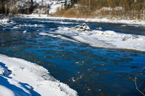 Frozen river with ice surface at winter Stock Photos