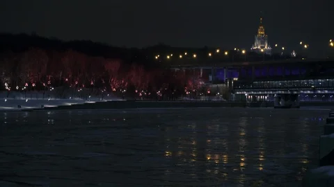Frozen river. Illuminated forest at winter night. Moscow State University. Luzhn 스톡 동영상 104338553