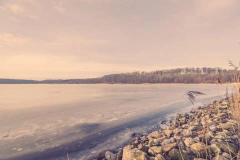 Frozen river landscape with pebbles Stock Photos