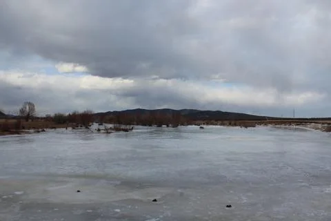 Frozen river landscape in springtime Stock Photos