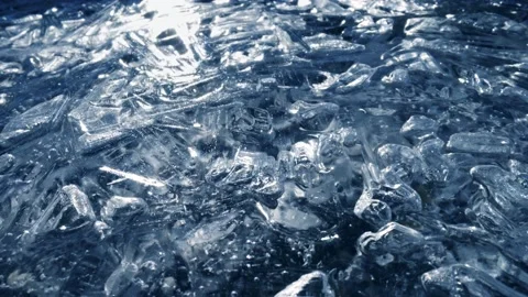 Frozen river macro shot. Whimsical ice patterns. Sun glitters reflected from the 스톡 동영상 145314004