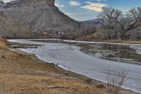 Frozen river in mountain shadow Fotos Stock