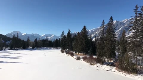 Frozen River in the Mountains in the Winter. Bow River in Banff, Alberta, Canada Stock Footage 129128750