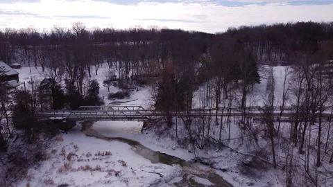 Frozen river revealing waterfall and gorge Stock Footage 228468597