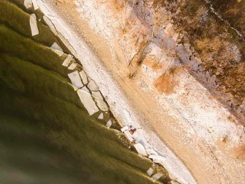 Frozen river. Riverside in winter time. Stock Photos