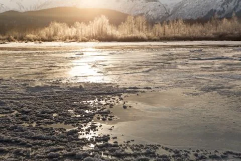 Frozen river with sun glow Stock Photos