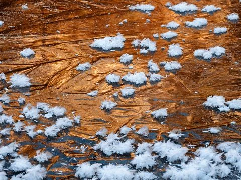 Frozen river: sunset light reflected in the ice, large crystals of frost. Stock Photos