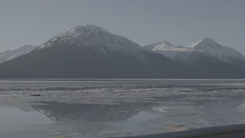 Frozen river surface and snow clad mountains Stock Footage 104526950
