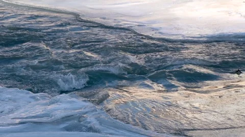 Frozen river surface with flowing ice - Abstract Backdrop and Natural Formation Stock Footage 339698272