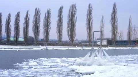 Frozen river on a very cold winter day - ice on the water and frozen dock Stock Footage 97163686