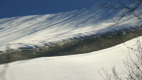 Frozen river with water running Stock Footage 230465785