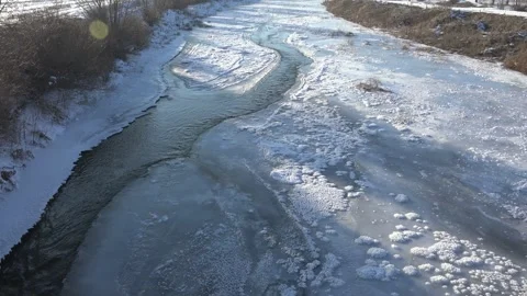 Frozen river waters with ice covered surface - Surface Crack and Winter Weather Stock Footage 339560298