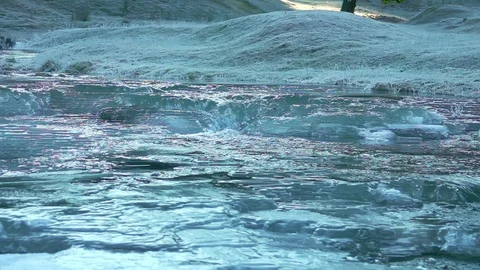 Frozen river in the winter mountain forest Stock Footage 99245331