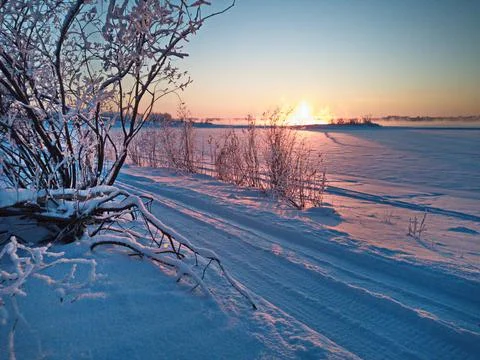 Frozen road at sunset Stock Photos