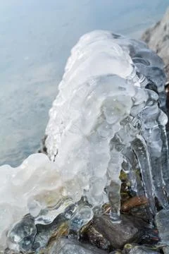 Frozen rocks with ice in the winter lake Stock Photos