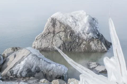 Frozen rocks with ice in the winter lake Stock Photos