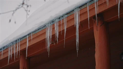 Frozen Roof Edge with Icicles on Rustic Home Video stock 309857972