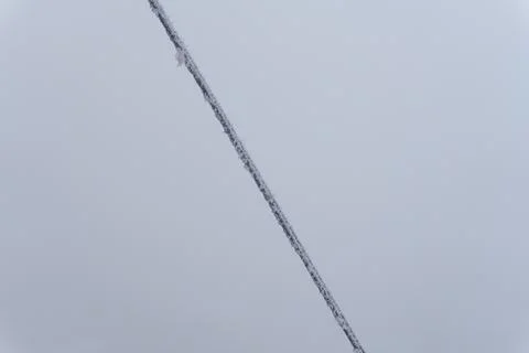 A frozen rope with icicles from the cold, a winter blizzard in the form of ice Stock Photos