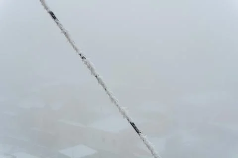 A frozen rope with icicles from the cold, a winter blizzard in the form of ice Stock Photos