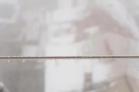 A frozen rope with icicles from the cold, a winter blizzard in the form of ice Stock Photos