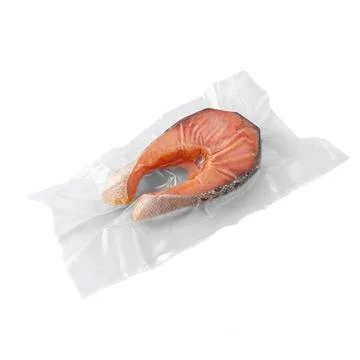 Frozen salmon steak. In plastic packaging. White background. Isolated. Stock Photos