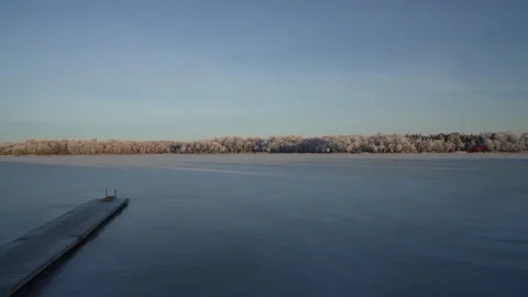 Frozen sea with bridge in foreground. Dusk light winter season- Stock Footage 285753080