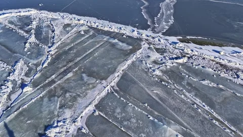 Frozen sea showing abstract patterns of breaking ice and snow in aerial view Stock Footage 330884808