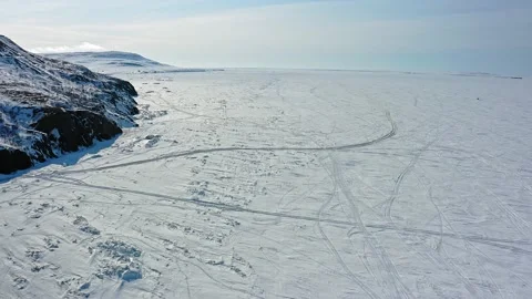 Frozen sea surface covered with white snow and ski trails Stock Footage 131797977