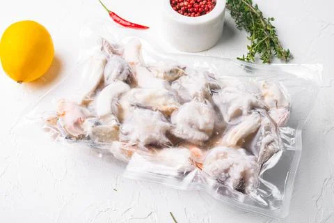 Frozen seafood pack, on white stone table background Stock Photos