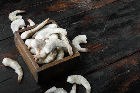 Frozen shell on Tiger Prawns or Asian tiger Shrimps, on old dark wooden table Stock Photos