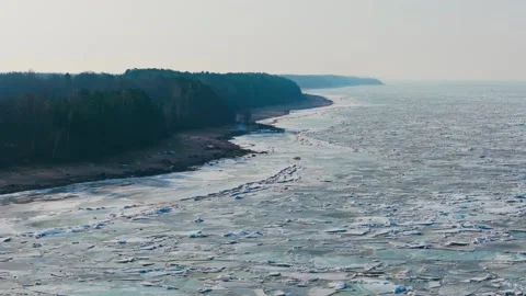 Frozen shoreline provides clean geospatial reference for AI climate observation Stock Footage 341845455
