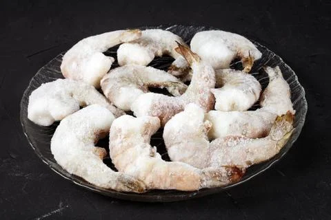 Frozen shrimp on a dark table close-up Stock Photos