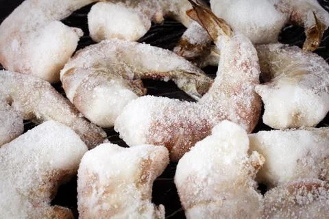 Frozen shrimp on a dark table close-up Stock Photos