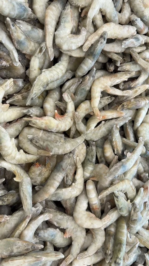 Frozen shrimps piled up as background in vertical format for seafood cuisin.. Stock Footage 319037701