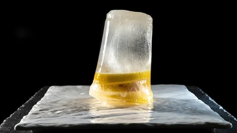 Frozen sliced lemon melts on dish. Time-lapse Stock Footage 107951300
