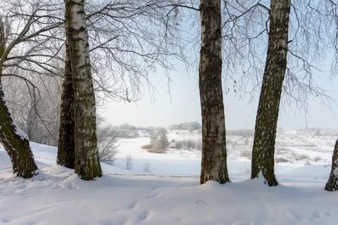 Frozen snow covered river in a winter landscape Stock Photos