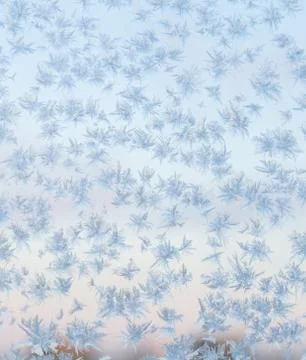 Frozen snowflakes on the window, winter background Stock Photos