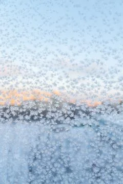 Frozen snowflakes on the window, winter background Stock Photos