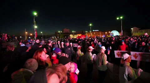 Frozen spectators of Sochi2014 Olympic torch relay on evening street in Stock Footage 33071646