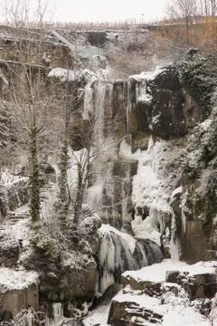 Frozen spring waterfall. 库存照片