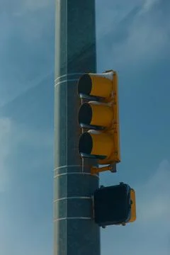 Frozen stoplight with dangling icicles beginning to melt after a snowstorm Stock Photos