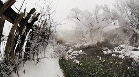 Frozen stream with waterfall and icicles in the winter, Ukraine Stock Footage 34911815